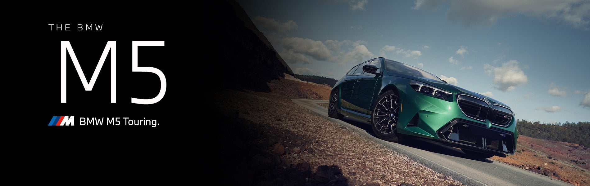 The new BMW M5 Touring in green driving down desert road | BMW of Roxbury in Kenvil NJ