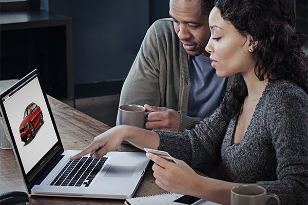 Man and woman working on laptop